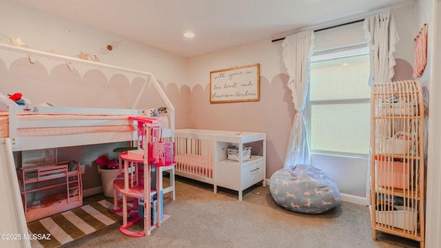 carpeted bedroom featuring baseboards