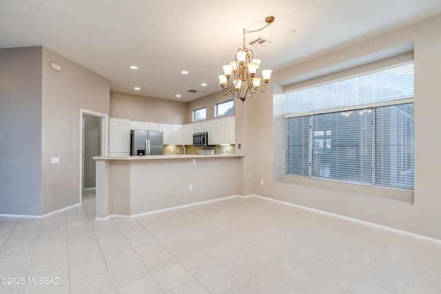 kitchen featuring appliances with stainless steel finishes, white cabinets, visible vents, and baseboards