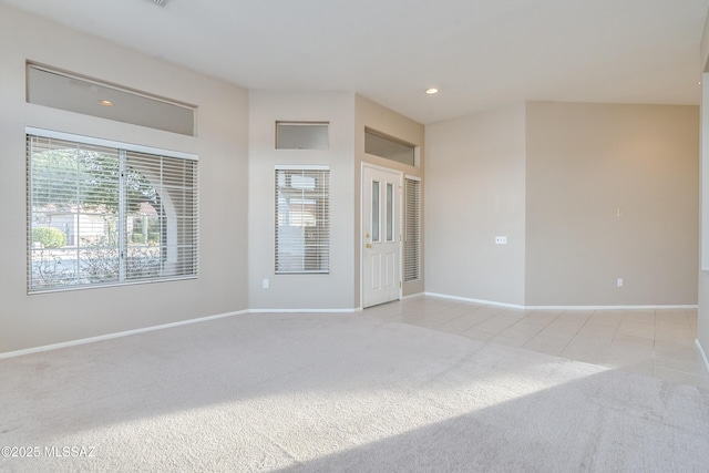 unfurnished room featuring light carpet, light tile patterned floors, recessed lighting, and baseboards