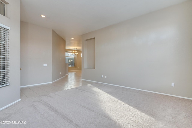 spare room with light tile patterned floors, recessed lighting, light carpet, a notable chandelier, and baseboards