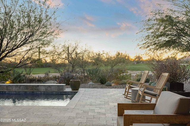 view of swimming pool featuring a fenced backyard and a patio