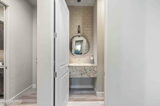 bathroom with vanity, baseboards, and wood finished floors