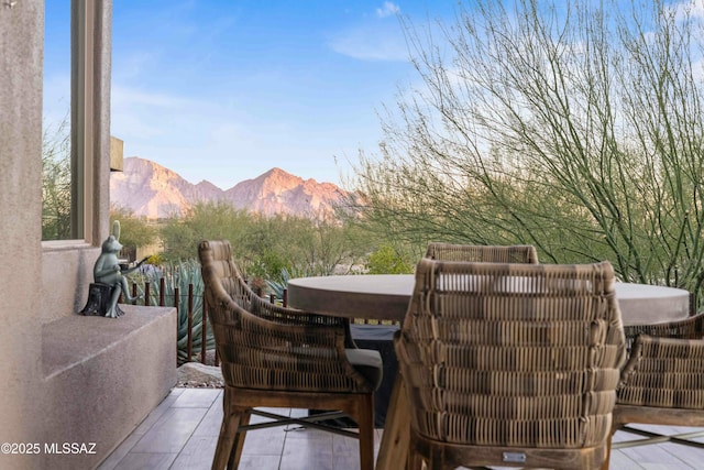 view of patio / terrace featuring a mountain view and a hot tub