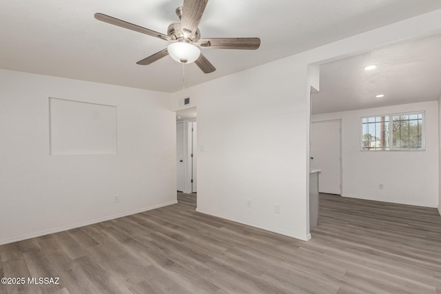 unfurnished room with ceiling fan, recessed lighting, wood finished floors, and baseboards