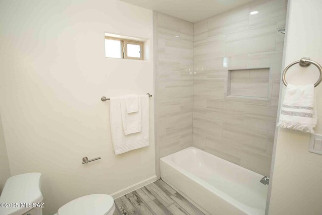 full bathroom featuring wood finish floors, bathtub / shower combination, and vanity