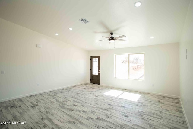 spare room featuring visible vents, recessed lighting, light wood-type flooring, and baseboards