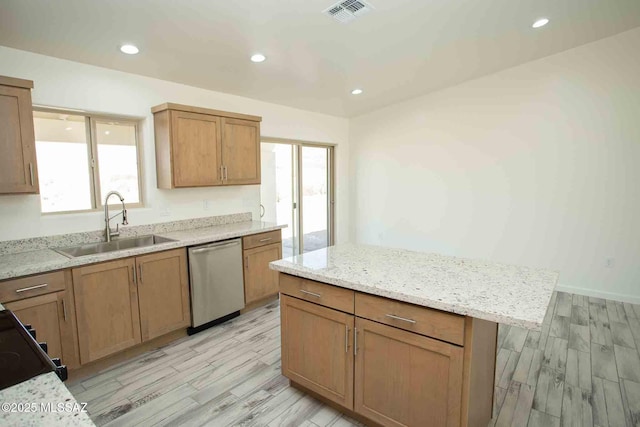 kitchen with light wood-style flooring, a sink, visible vents, light stone countertops, and dishwasher