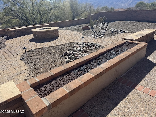 view of patio with an outdoor fire pit and a fenced backyard