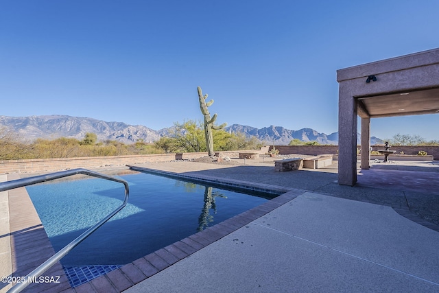 pool featuring a mountain view and a patio