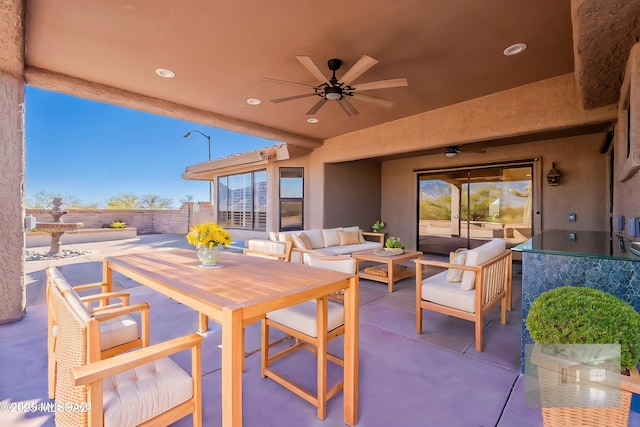 view of patio / terrace with fence, outdoor lounge area, and a ceiling fan