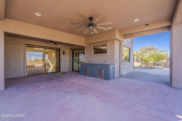 view of patio / terrace with ceiling fan and an outdoor kitchen