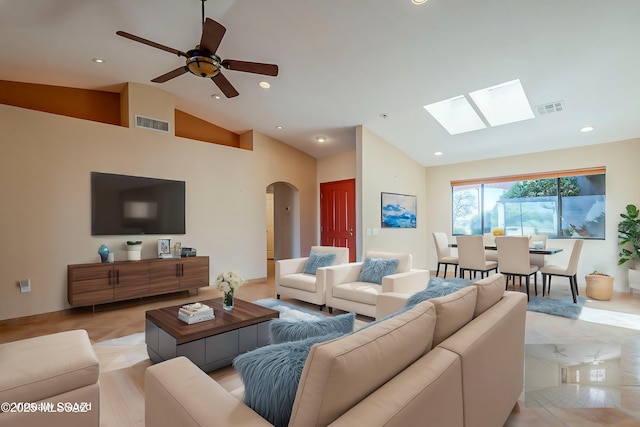 living area with light tile patterned floors, visible vents, arched walkways, lofted ceiling, and recessed lighting