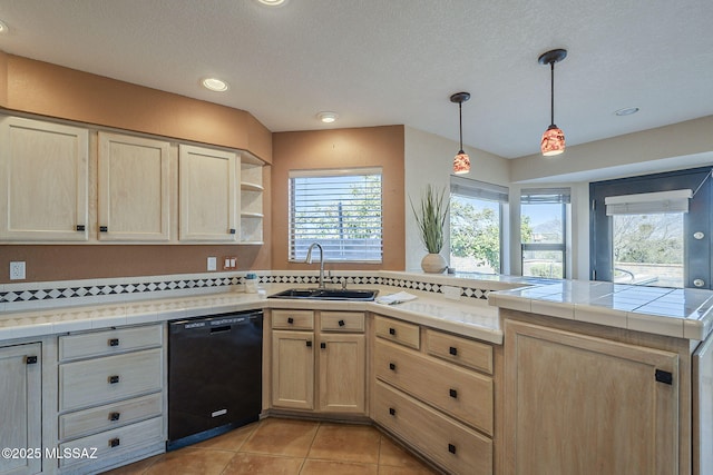 kitchen with a healthy amount of sunlight, light brown cabinets, a sink, dishwasher, and a peninsula