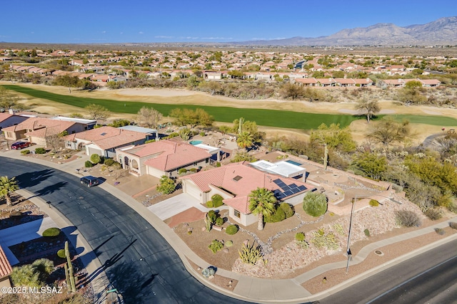 drone / aerial view with a residential view, a mountain view, and golf course view