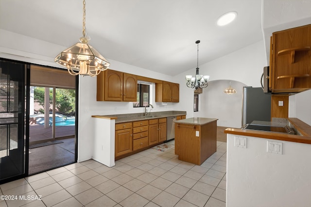 kitchen with light tile patterned floors, stainless steel appliances, a sink, vaulted ceiling, and a center island