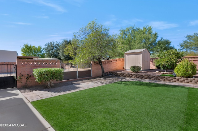 view of yard with fence private yard, a storage shed, and an outdoor structure