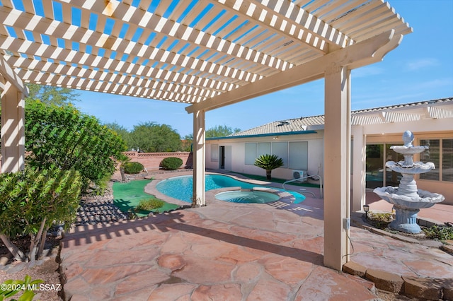 view of pool featuring a patio area, fence, and an in ground hot tub