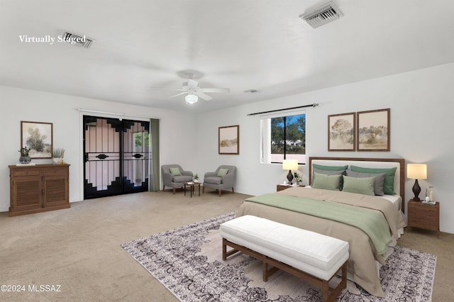 bedroom featuring light colored carpet, visible vents, and a ceiling fan