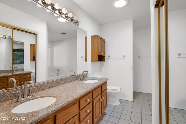 bathroom featuring double vanity, tile patterned flooring, and a sink