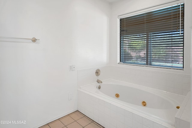 bathroom featuring tile patterned flooring and a tub with jets