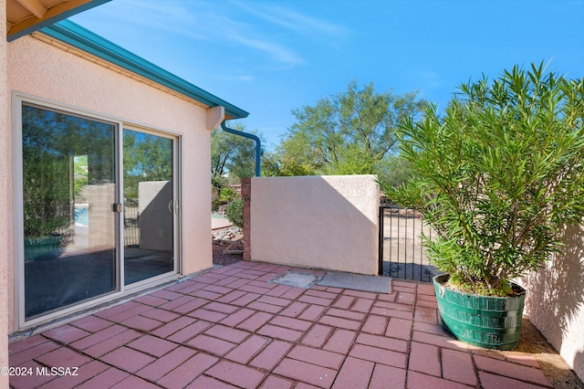 view of patio with a gate and fence