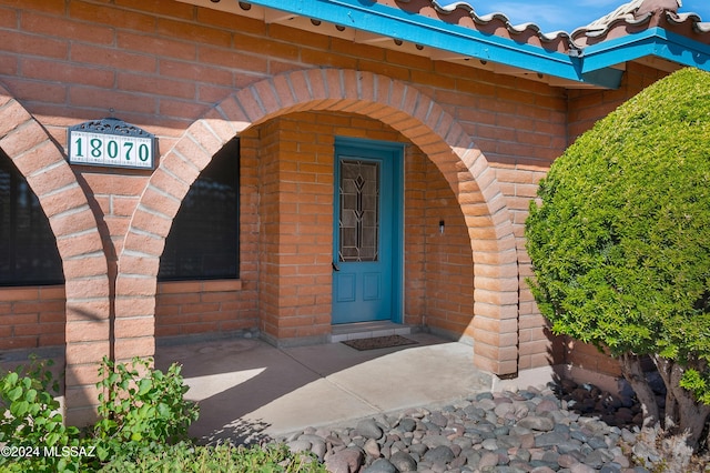 property entrance with brick siding