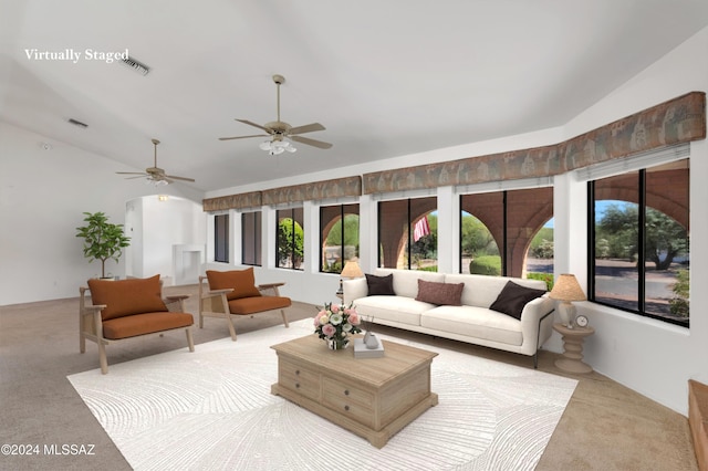 carpeted living room featuring lofted ceiling, a healthy amount of sunlight, and visible vents