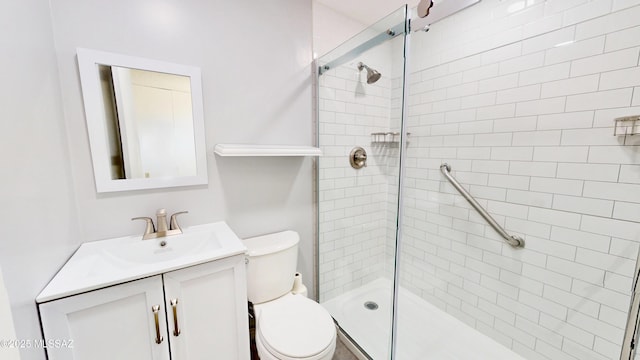 bathroom featuring a stall shower, vanity, and toilet