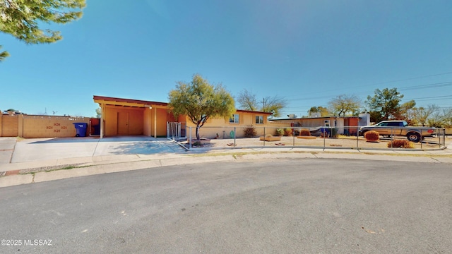 ranch-style home featuring a fenced front yard