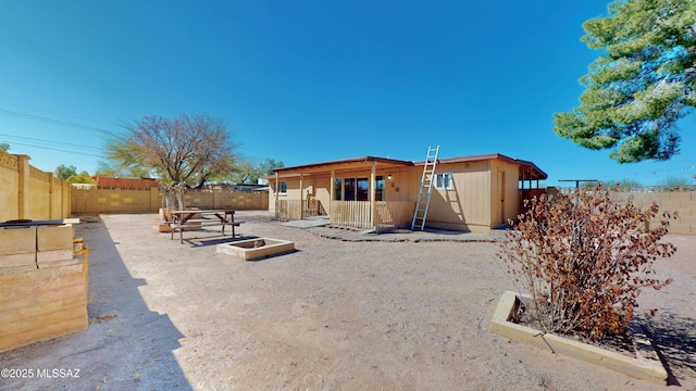 back of property with a fenced backyard