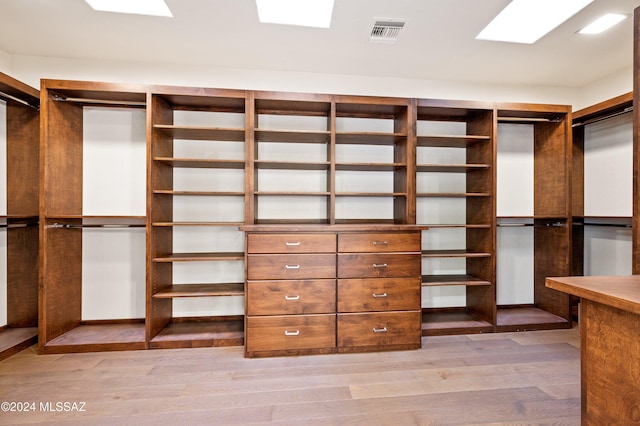 walk in closet with light wood-style flooring and visible vents