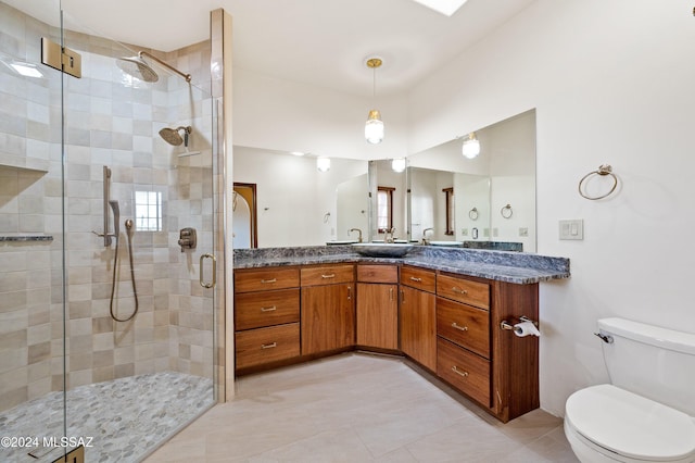 full bathroom with toilet, a stall shower, tile patterned floors, and vanity