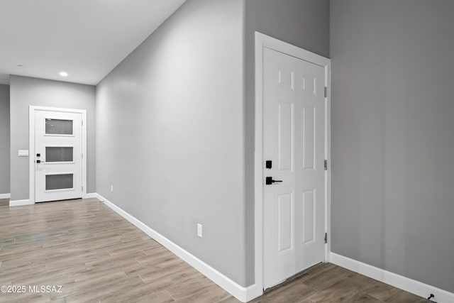 foyer entrance with recessed lighting, wood finished floors, and baseboards