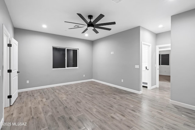 empty room with visible vents, baseboards, ceiling fan, light wood-style floors, and recessed lighting