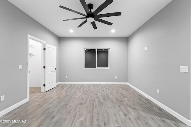 unfurnished room with ceiling fan, recessed lighting, wood finished floors, and baseboards