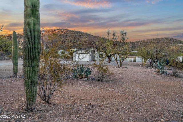 view of yard featuring fence and a mountain view