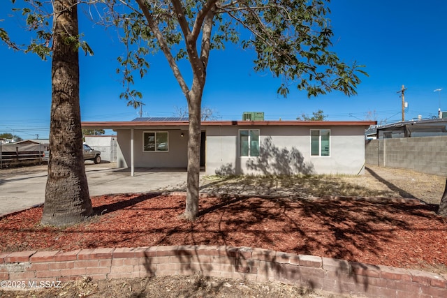 ranch-style house with fence, a patio, and stucco siding