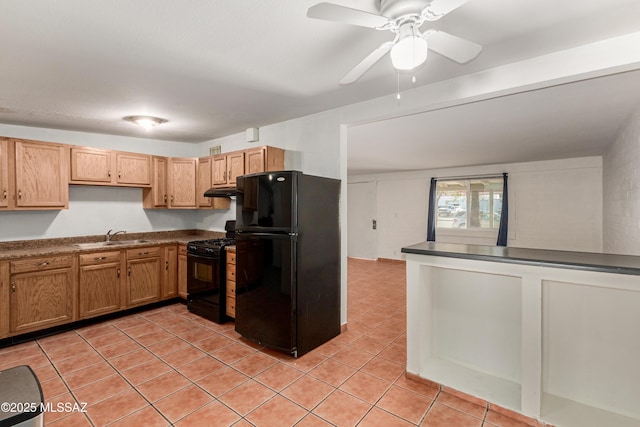 kitchen with light tile patterned floors, ceiling fan, a sink, black appliances, and dark countertops