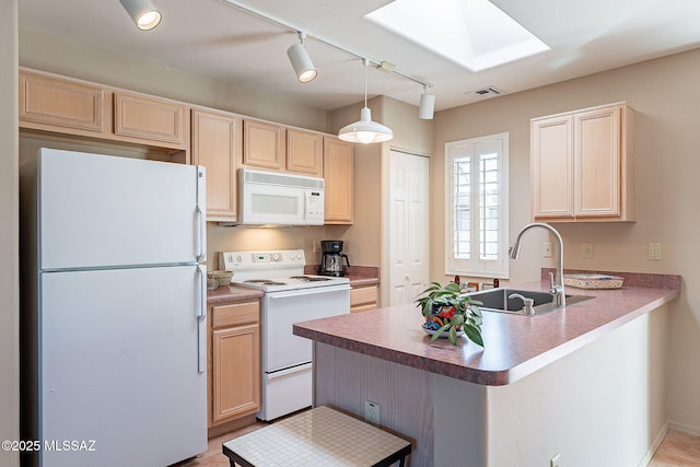 kitchen with light brown cabinets, a peninsula, white appliances, a sink, and visible vents