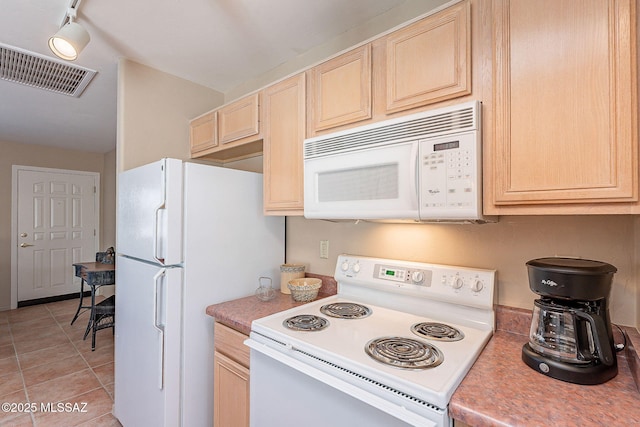 kitchen featuring white appliances, light tile patterned floors, visible vents, light countertops, and light brown cabinetry