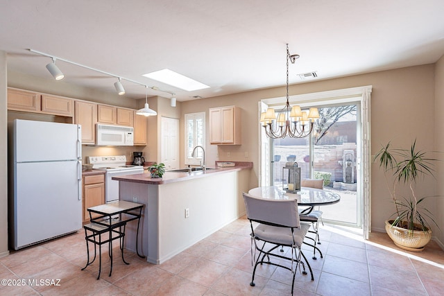 kitchen featuring white appliances, visible vents, a sink, and light brown cabinetry