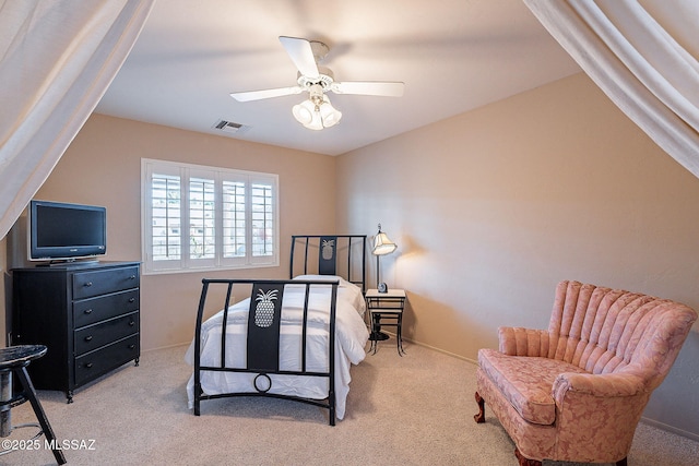 carpeted bedroom featuring a ceiling fan and visible vents