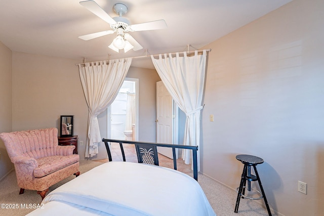 bedroom with a ceiling fan, light colored carpet, connected bathroom, and baseboards