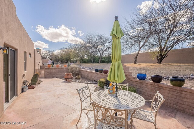 view of patio / terrace featuring outdoor dining area and a fenced backyard