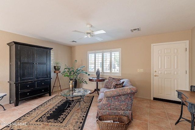 living area with visible vents, a ceiling fan, and light tile patterned flooring