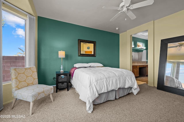 bedroom featuring carpet, baseboards, ceiling fan, and connected bathroom