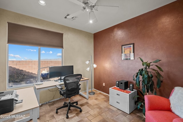 home office featuring recessed lighting, visible vents, a textured wall, a ceiling fan, and stone finish flooring