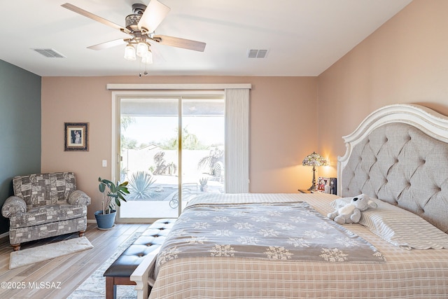 bedroom featuring access to exterior, ceiling fan, visible vents, and wood finished floors