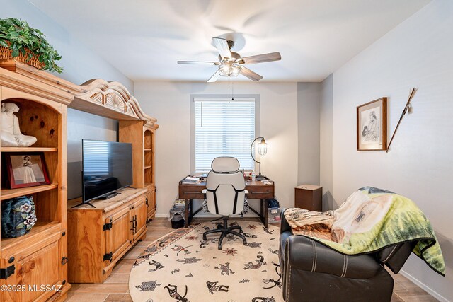 office featuring light wood-style floors, ceiling fan, and baseboards