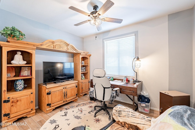 office space featuring wood tiled floor, ceiling fan, and baseboards